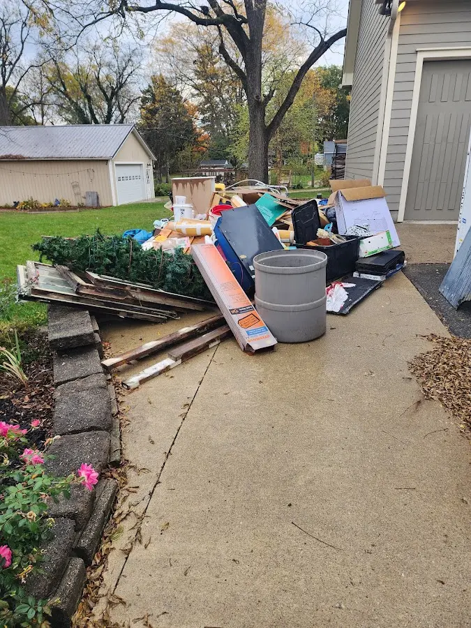 Dumpster being loaded with debris for Estate Cleanout Dumpster Rental in Seaside
